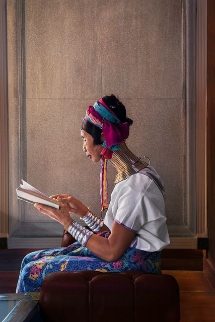 Steve McCurry, A woman reads in the light coming through the window, Chiang Mai, Thailand, 2012